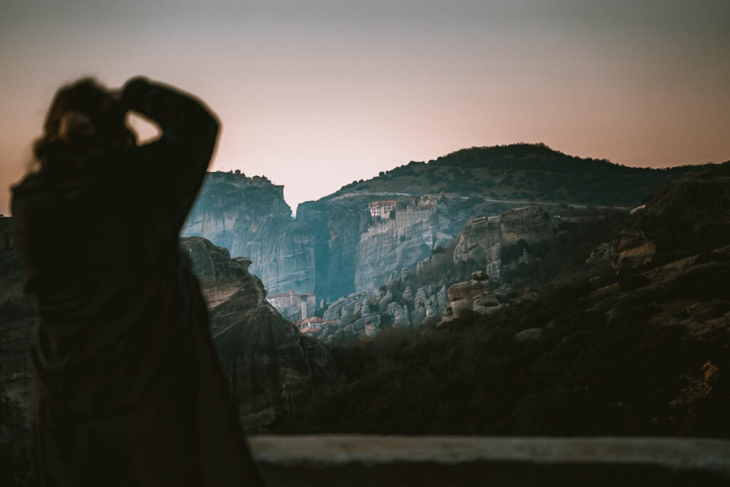 A female photographs a monastery
