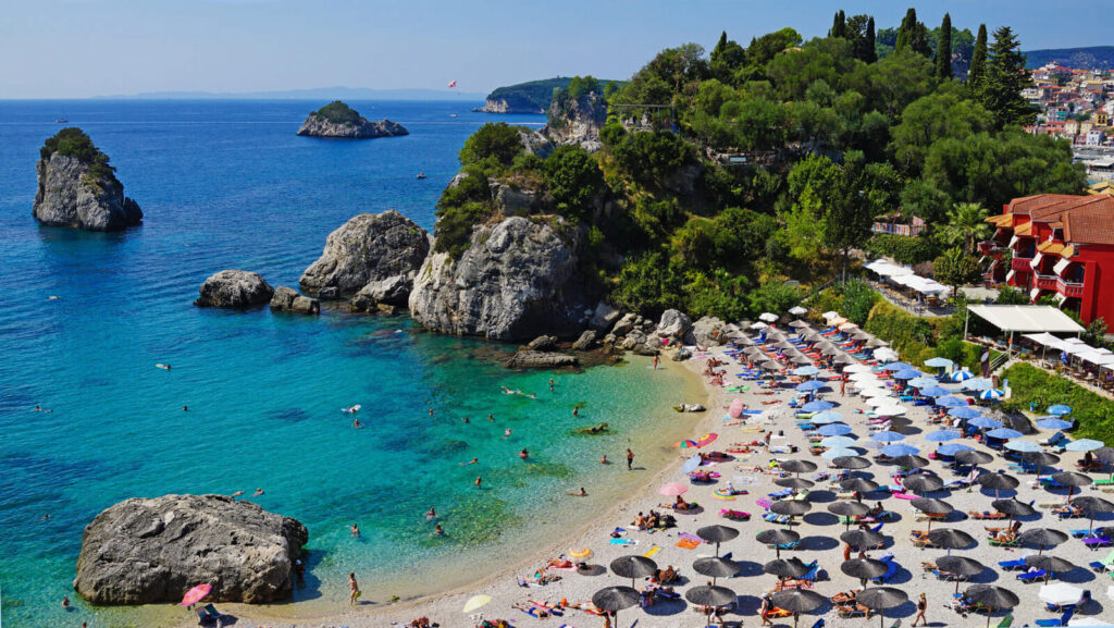 A beach from above with umbrellas and sunbeds