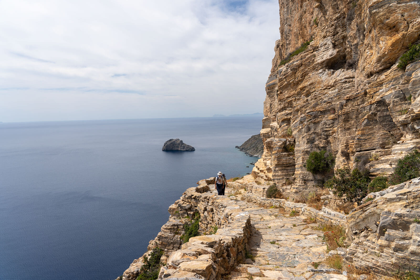 Hikers climbing the stoned path to Mary Chozoviotissa Monastery