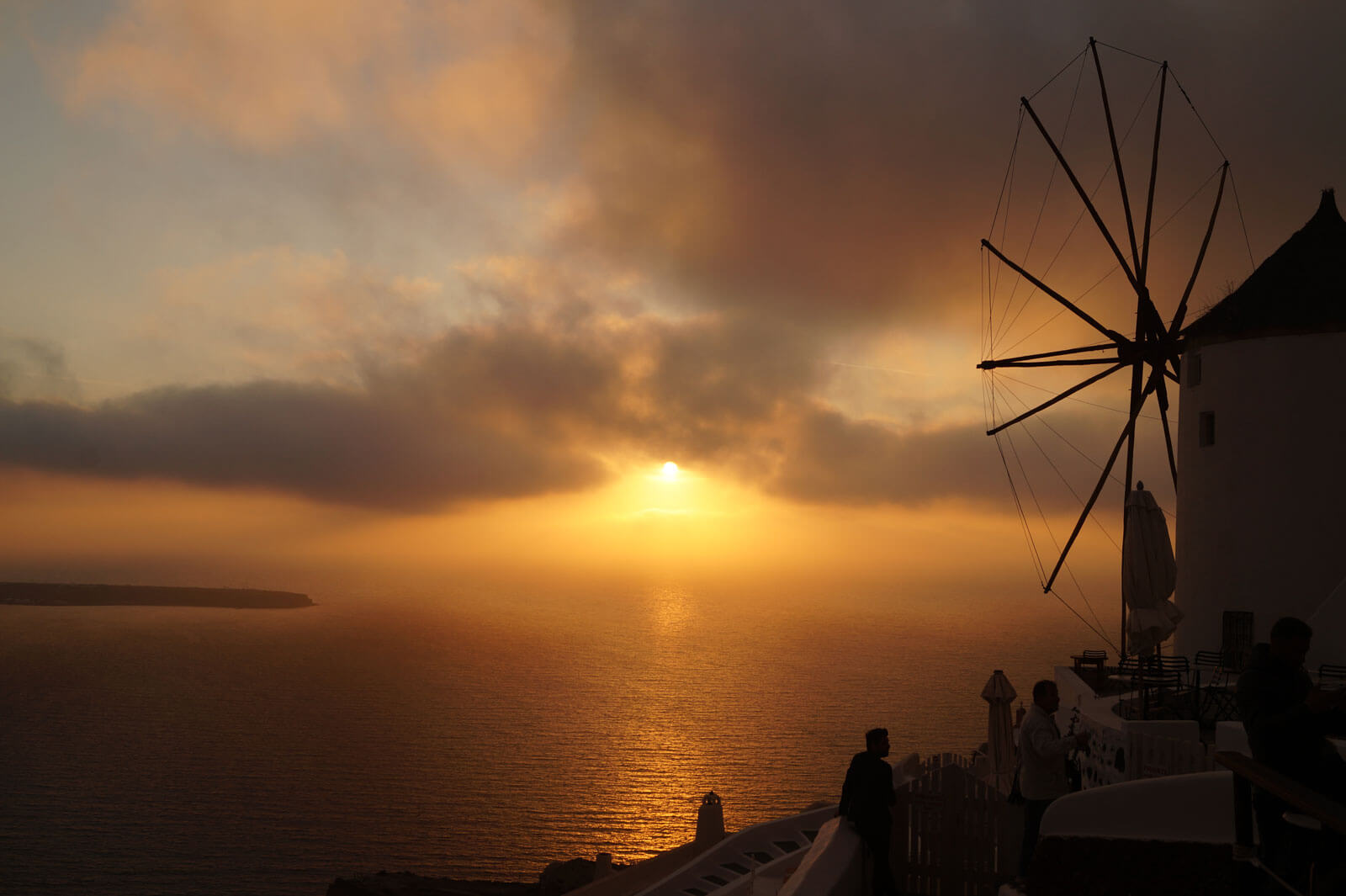 People watching the sun as it sets in Oia